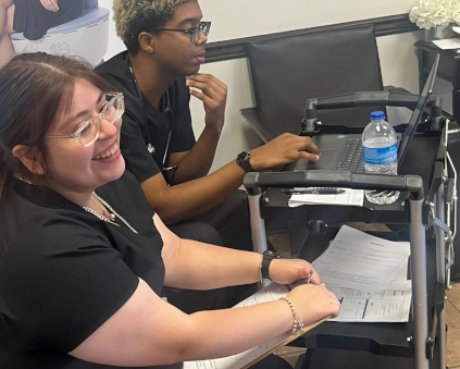 medical assistant students working on a computer in class