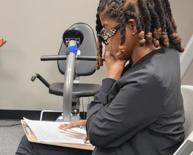 student reviewing paper work for a patient